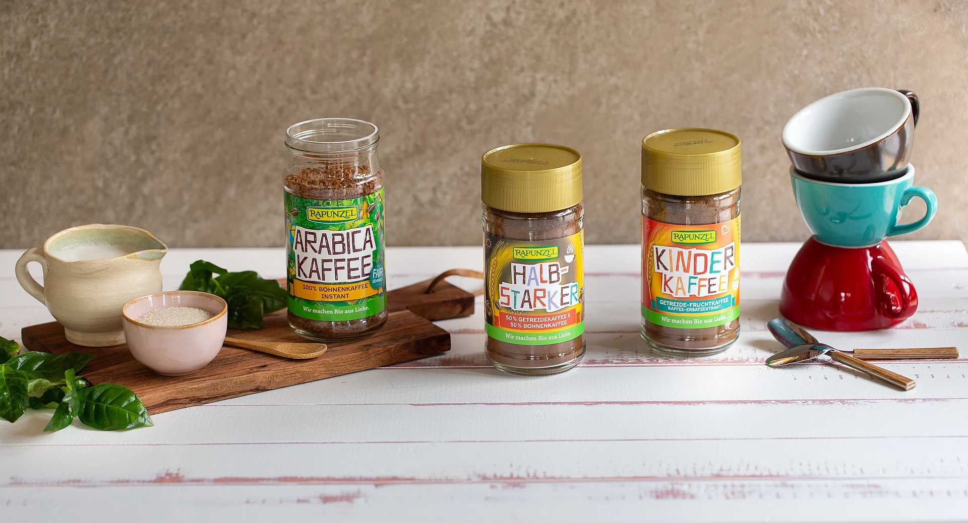 Instantkaffee, Getreidekaffee, Kinderkaffee. Mehrere Gläser mit Rapunzel Instant-Kaffee nebeneinander auf einem Tisch